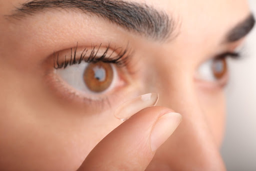 A woman putting in a contact lens