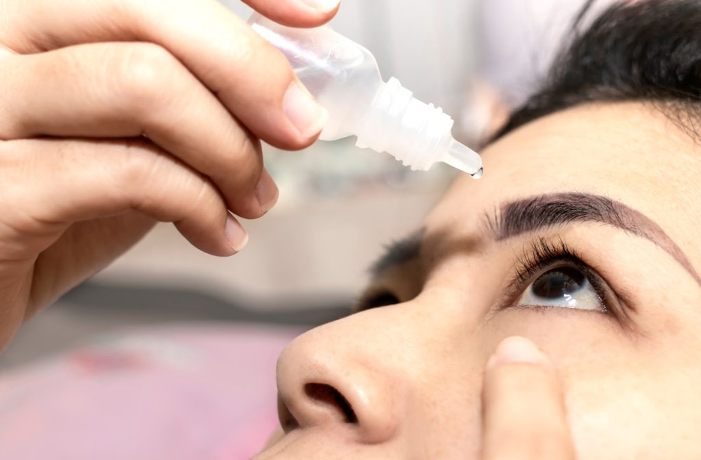 Woman applying over the counter eye drops